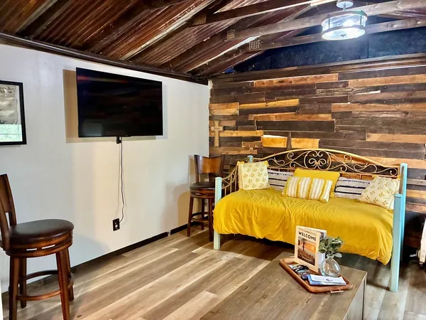 a bed room with a bed and a television