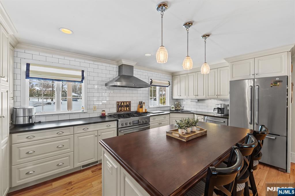 2 Overbrook Place Hillsdale, NJ 07642 - Photo 11 of 49 a kitchen with a table stainless steel appliances and cabinets