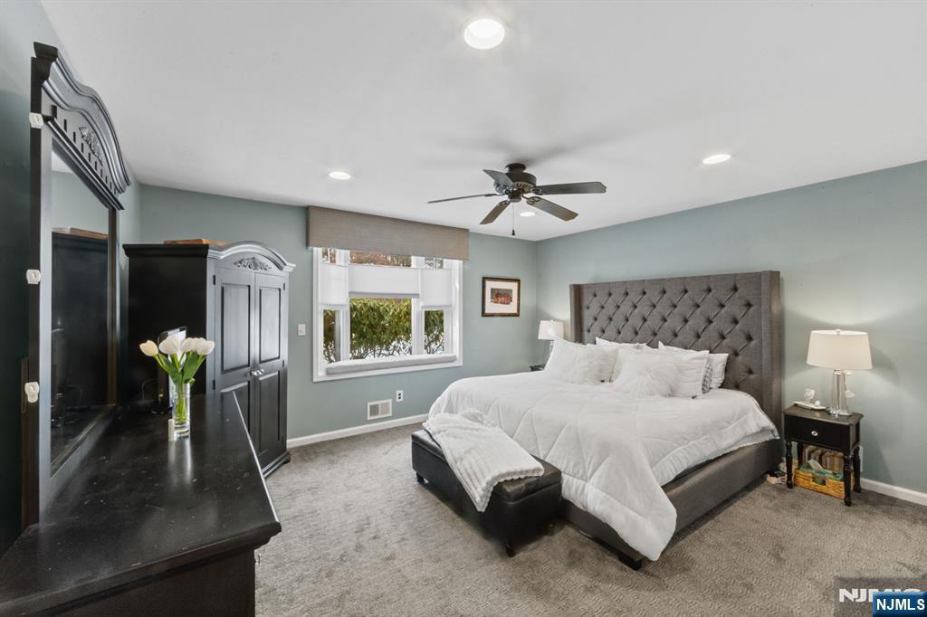 2 Overbrook Place Hillsdale, NJ 07642 - Photo 20 of 49 a spacious bedroom with a bed a dresser and potted plant