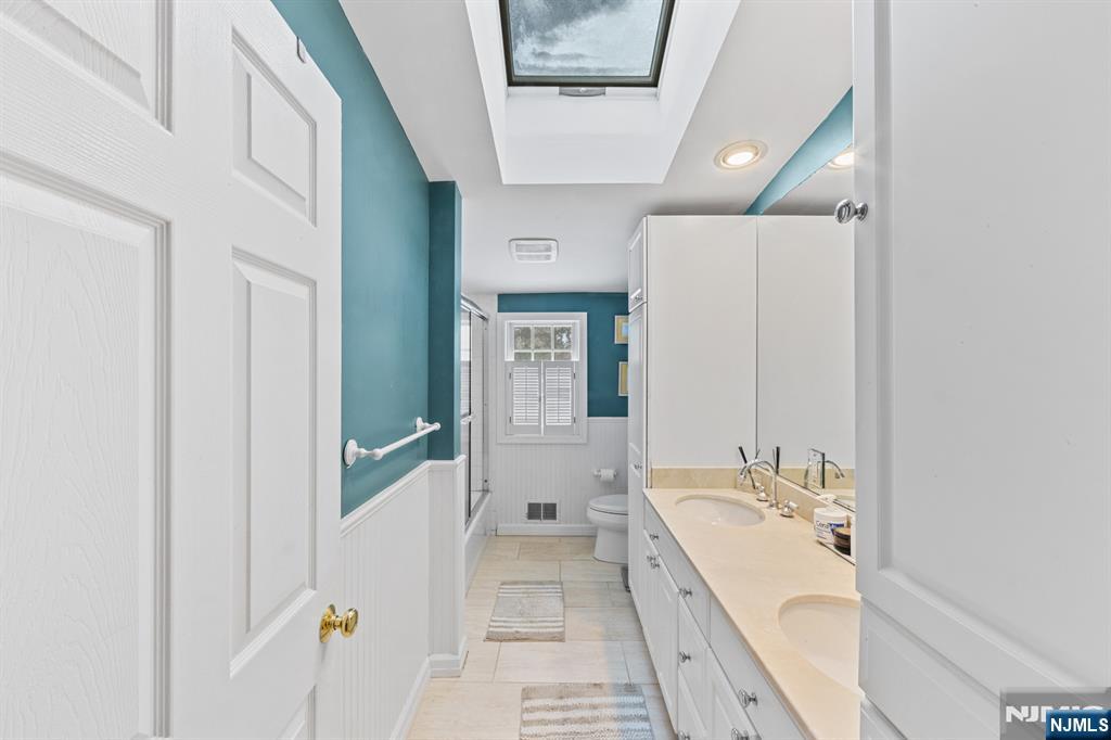 2 Overbrook Place Hillsdale, NJ 07642 - Photo 25 of 49 a spacious bathroom with a double vanity sink and a bathtub