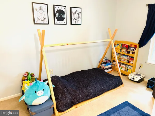 a bedroom with a bed and a potted plant