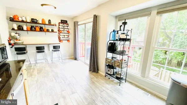 a view of a living room with furniture and large window