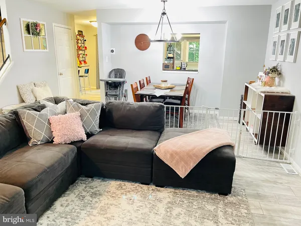 a living room with furniture a couch and a dining table
