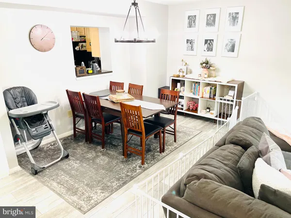 a living room with furniture a rug and a table