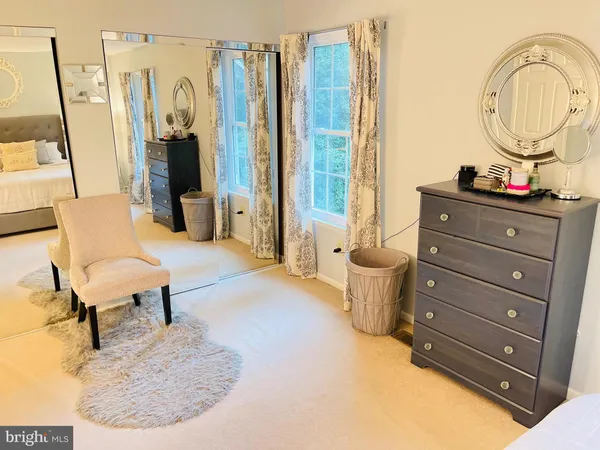 a living room with furniture and a mirror