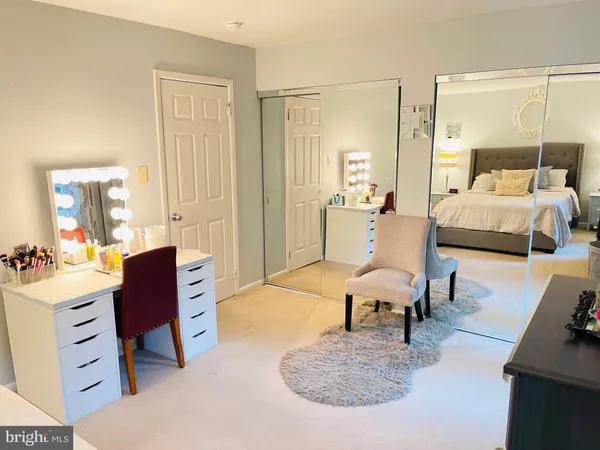 a bedroom with furniture and a large window