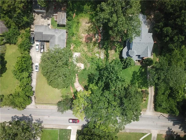 an aerial view of a house with a yard and garden
