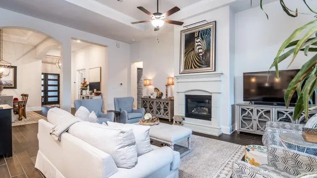 a living room with furniture a flat screen tv and a fireplace