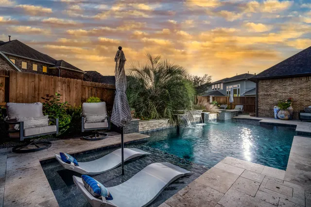 a view of a patio with swimming pool table and chairs