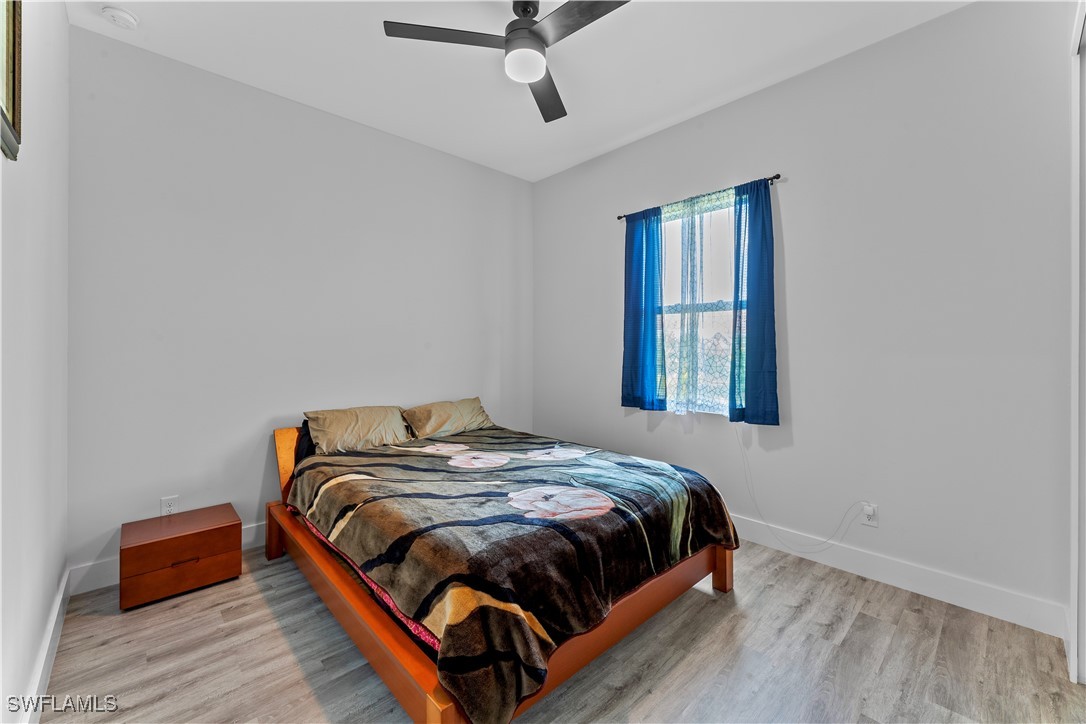 3002 42nd Street Southwest Lehigh Acres, FL 33976 - Photo 13 of 25 a bedroom with a bed and window