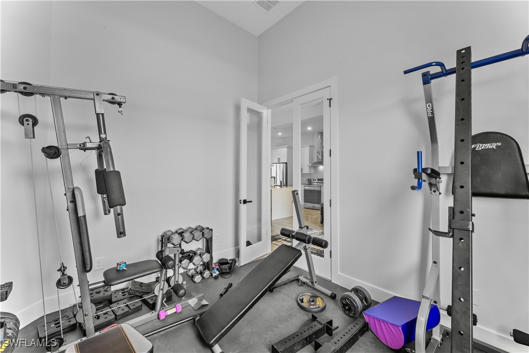 3002 42nd Street Southwest Lehigh Acres, FL 33976 - Photo 14 of 25 a view of a room with gym equipment