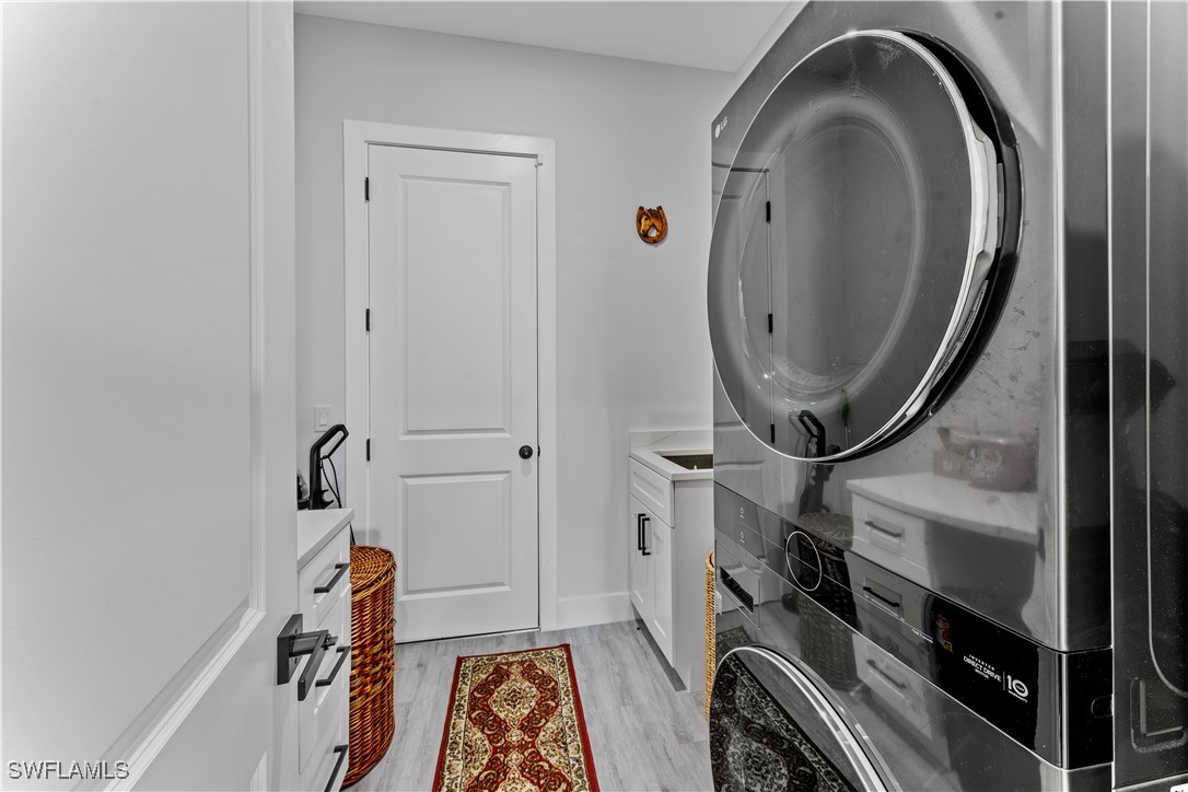 3002 42nd Street Southwest Lehigh Acres, FL 33976 - Photo 17 of 25 a view of a storage and utility room with washer and dryer