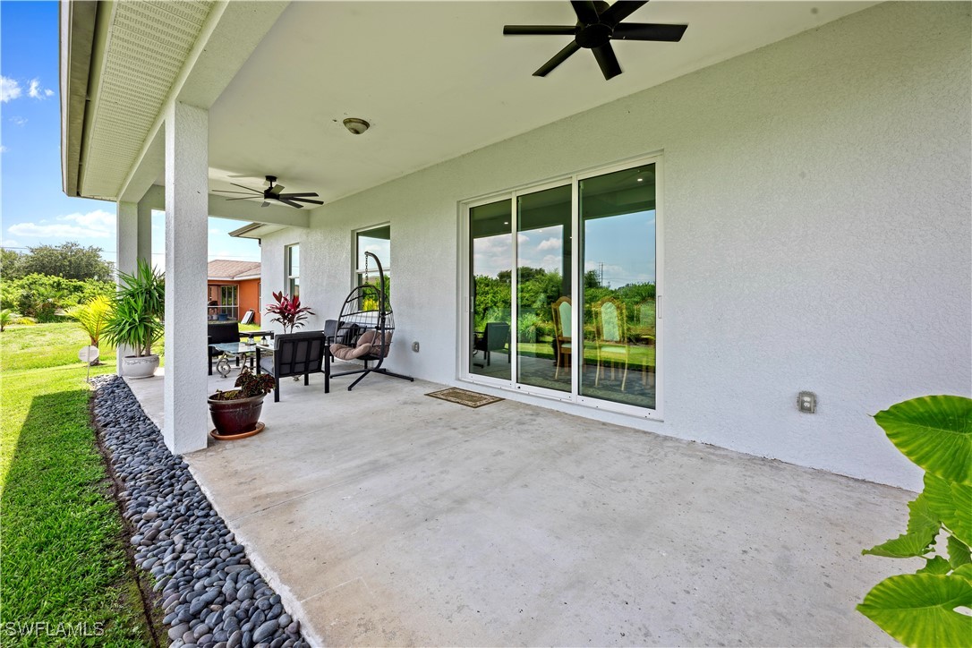 3002 42nd Street Southwest Lehigh Acres, FL 33976 - Photo 18 of 25 a view of a livingroom with a patio and a garden