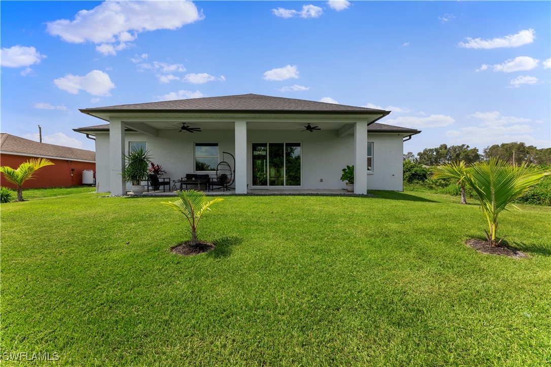 3002 42nd Street Southwest Lehigh Acres, FL 33976 - Photo 20 of 25 a view of a house with a yard
