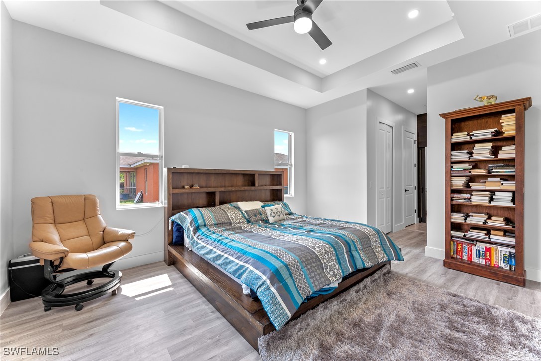 3002 42nd Street Southwest Lehigh Acres, FL 33976 - Photo 6 of 25 a bedroom with a bed and a couch