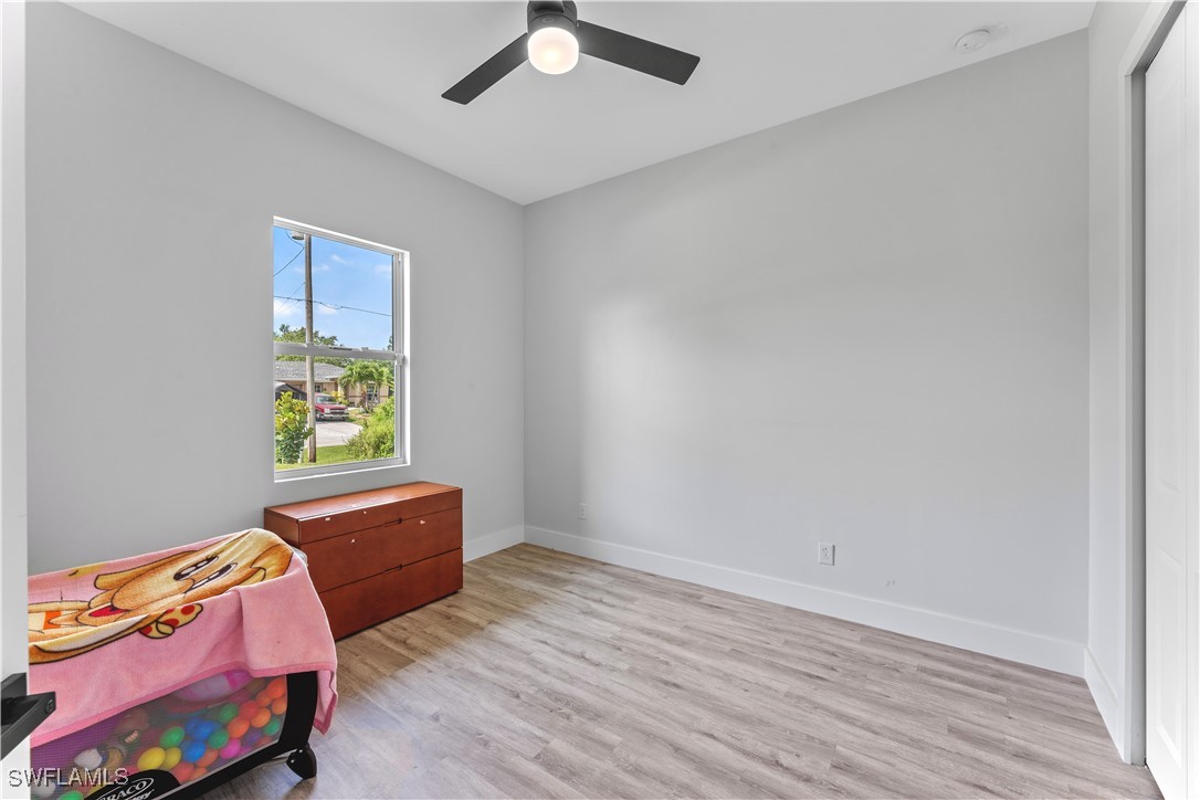3002 42nd Street Southwest Lehigh Acres, FL 33976 - Photo 10 of 25 a bedroom with a bed and a window