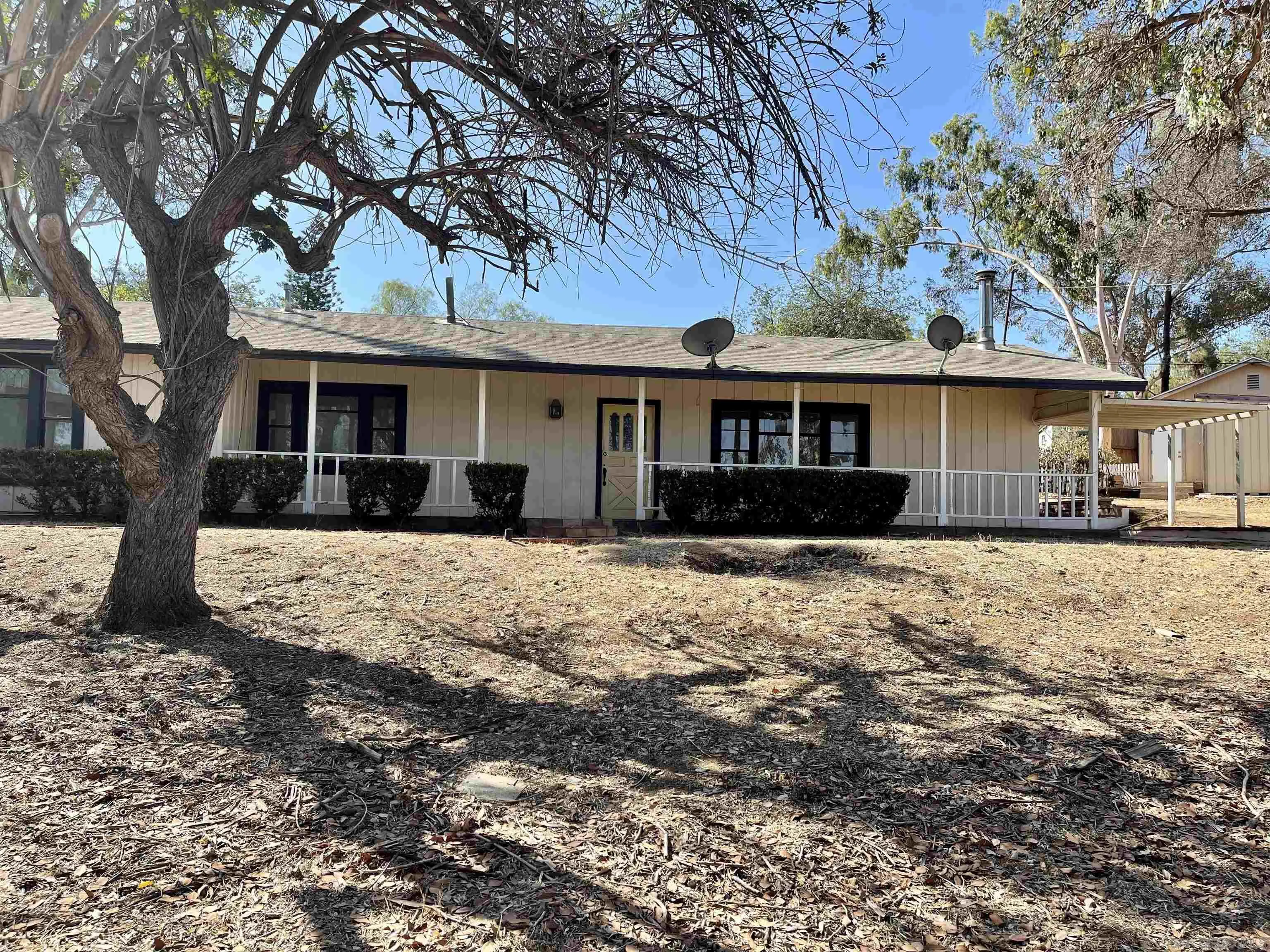 a front view of a house with a yard covered with snow