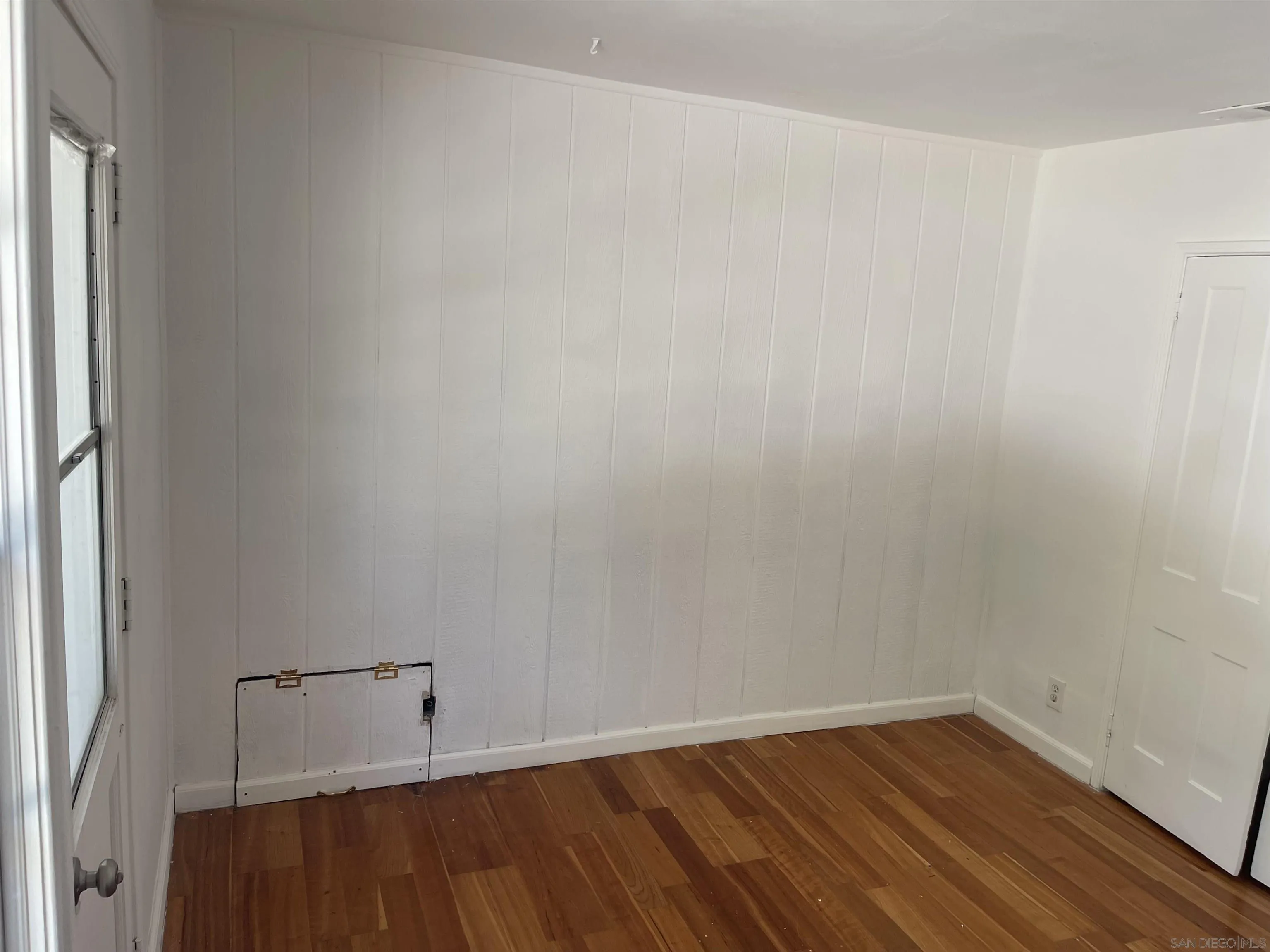 1367 Green Canyon Road Fallbrook, CA 92028 - Photo 11 of 42 a view of an empty room with wooden floor and a window