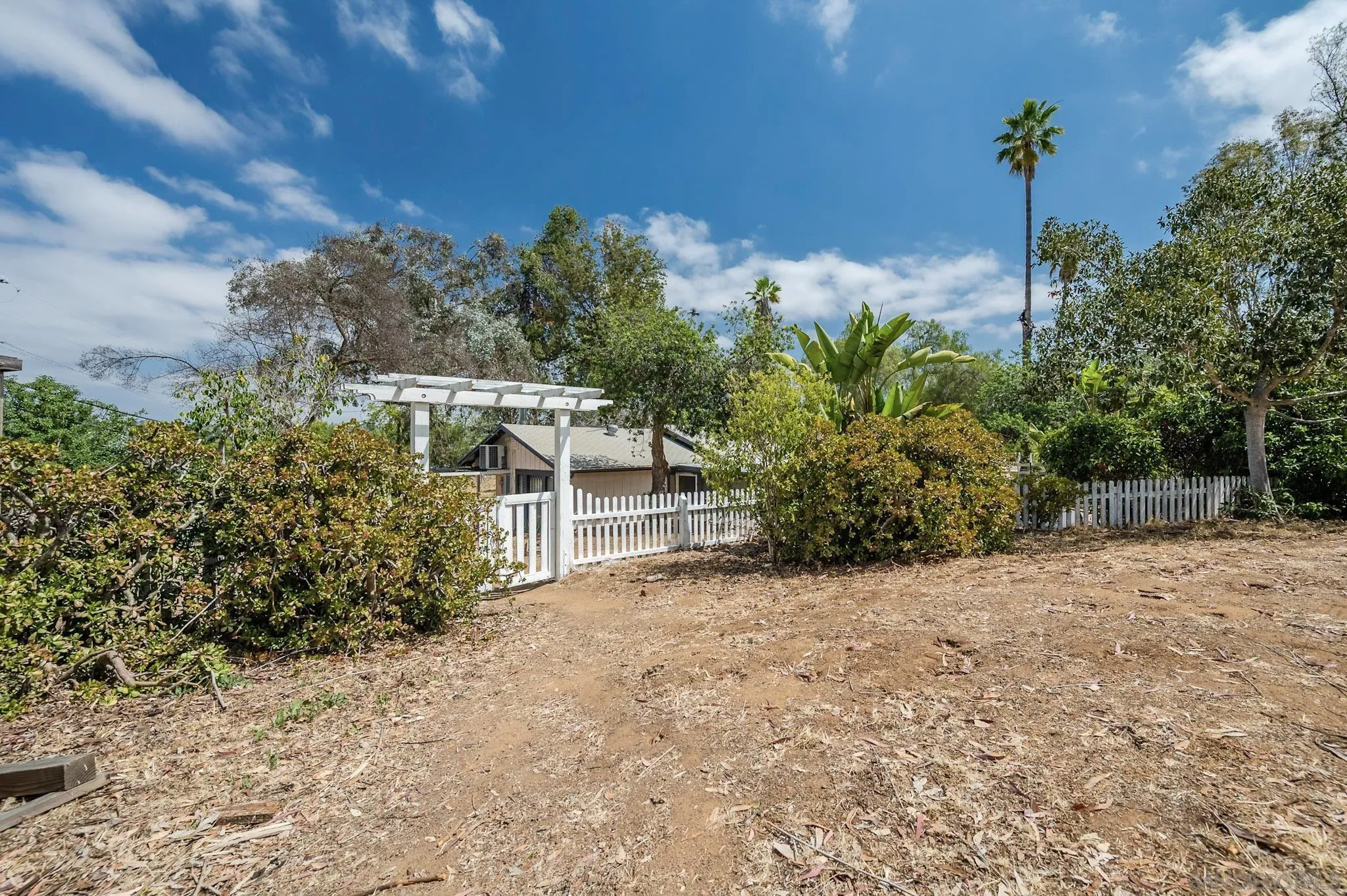 1367 Green Canyon Road Fallbrook, CA 92028 - Photo 25 of 42 a view of a house with a yard and potted plants