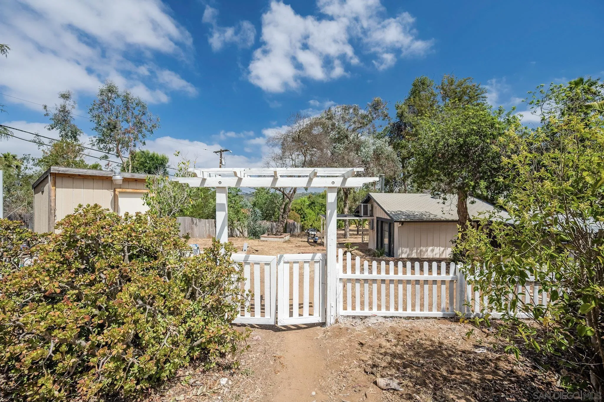 1367 Green Canyon Road Fallbrook, CA 92028 - Photo 27 of 42 a front view of a house with a garden