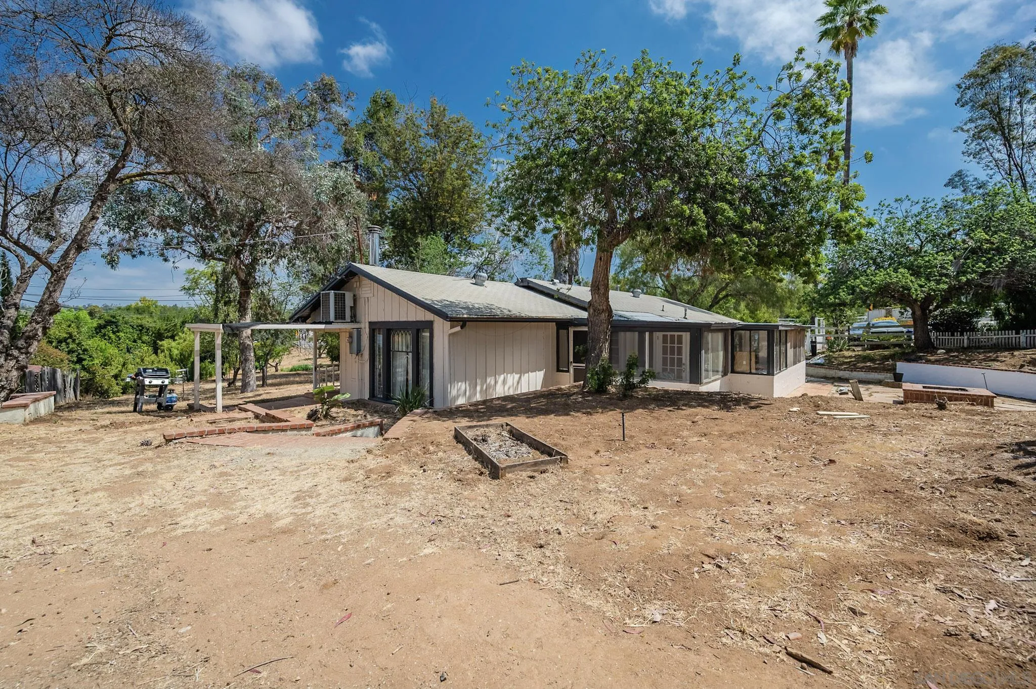 1367 Green Canyon Road Fallbrook, CA 92028 - Photo 29 of 42 a view of a house with a yard and sitting area