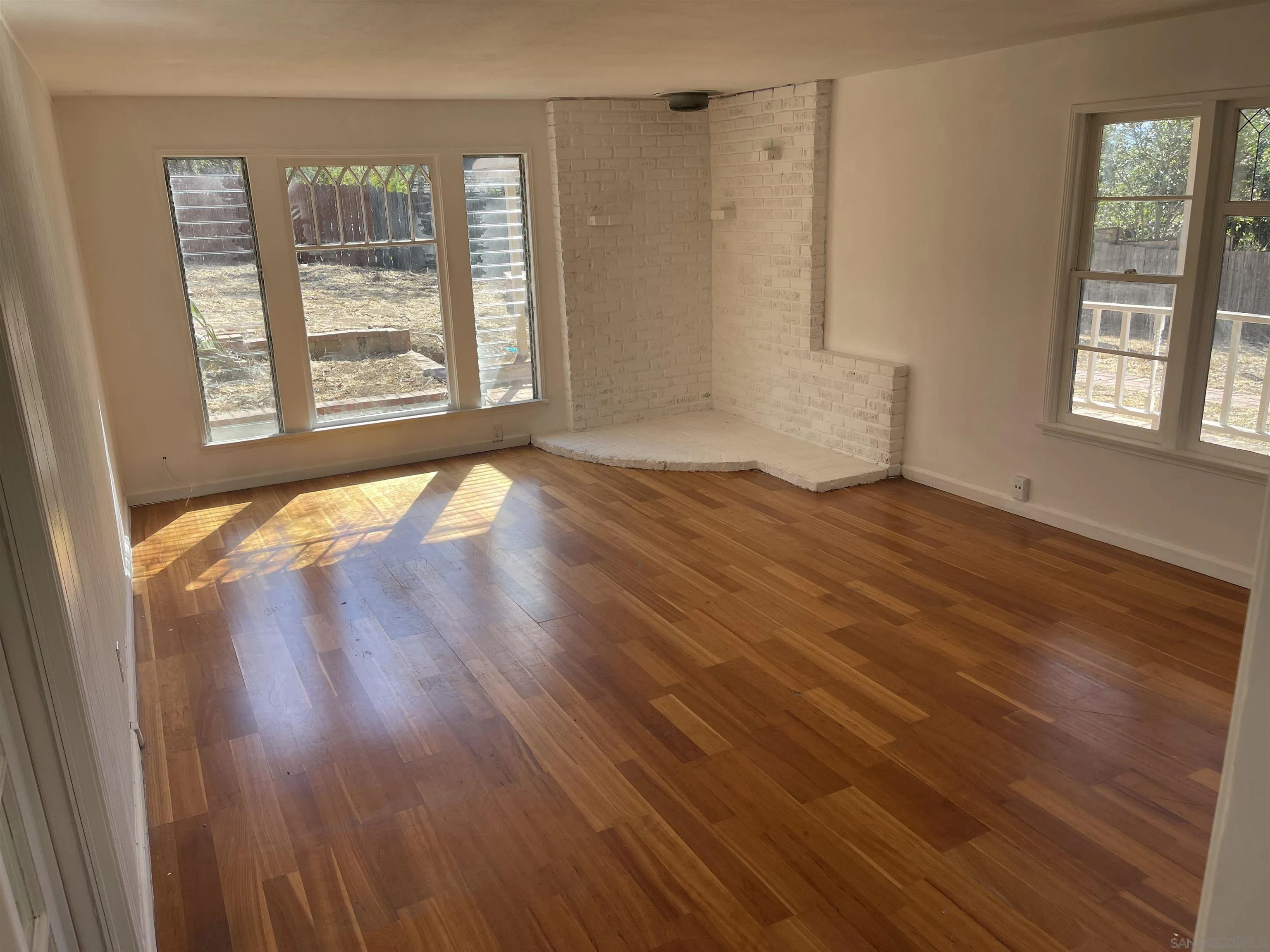 1367 Green Canyon Road Fallbrook, CA 92028 - Photo 3 of 42 a view of an empty room with wooden floor and a window