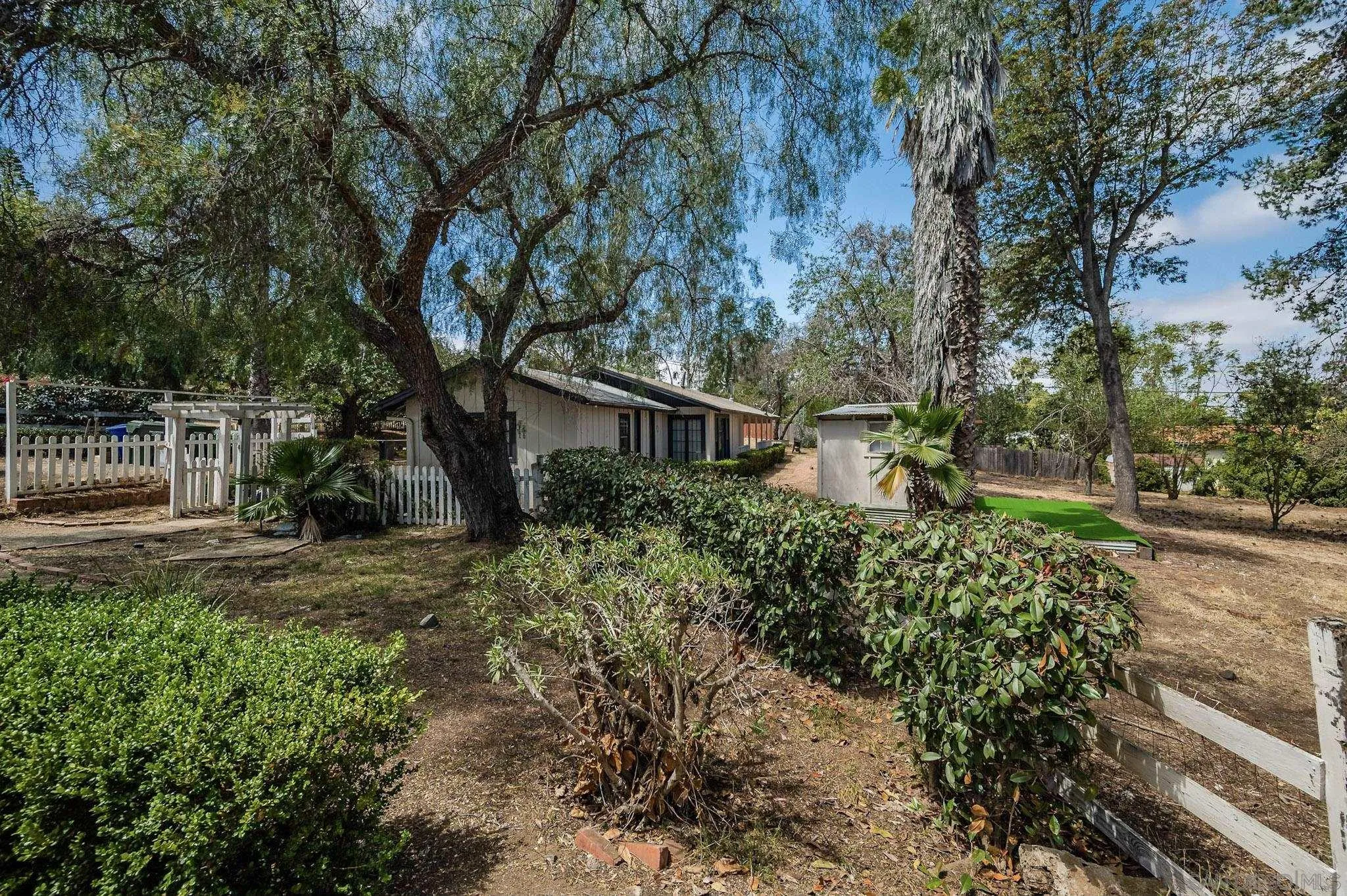 1367 Green Canyon Road Fallbrook, CA 92028 - Photo 38 of 42 a view of a house with a yard