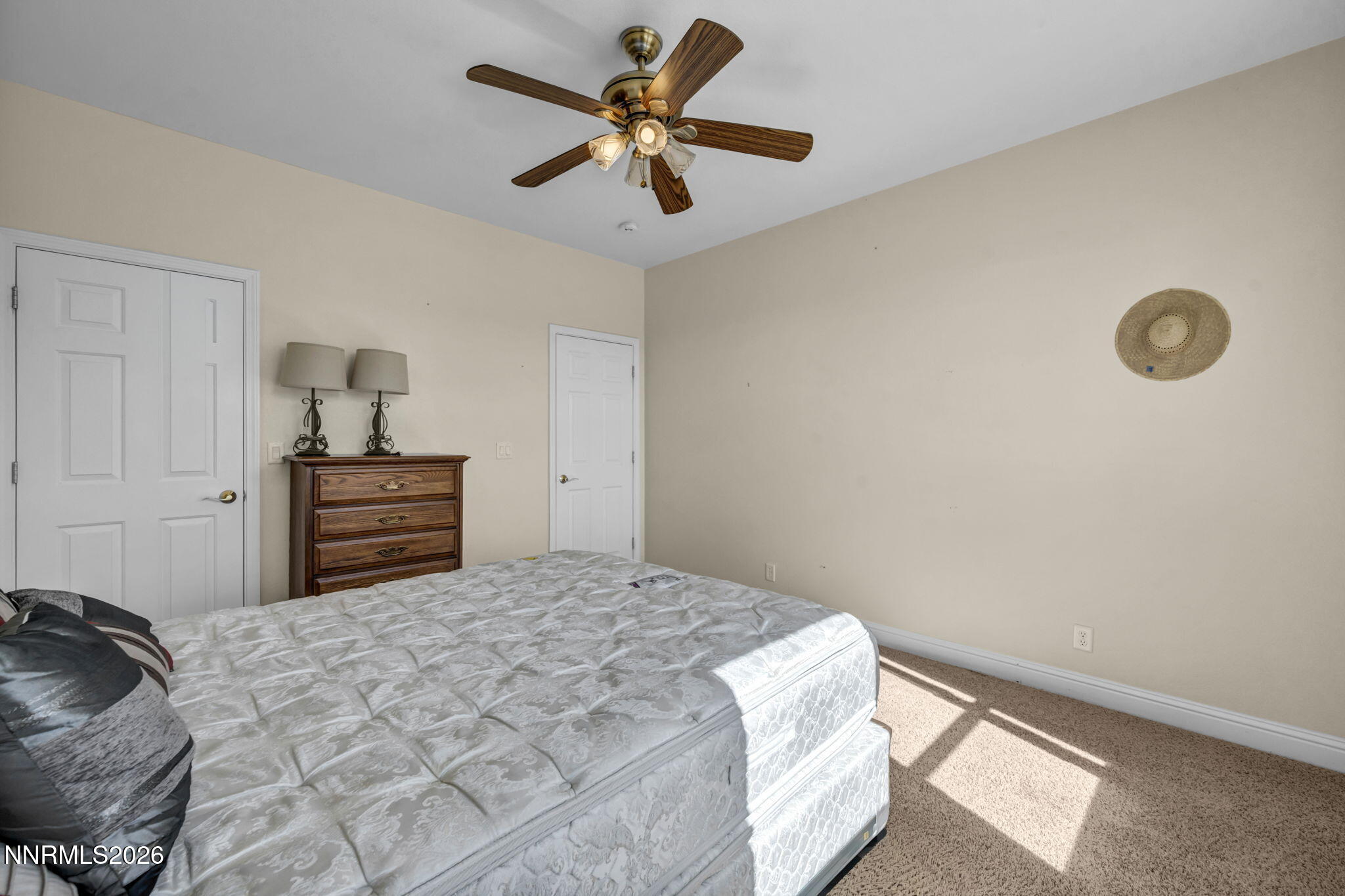 68 Kari Lane Smith Valley, NV 89430 - Photo 14 of 42 a bedroom with a bed and a chandelier