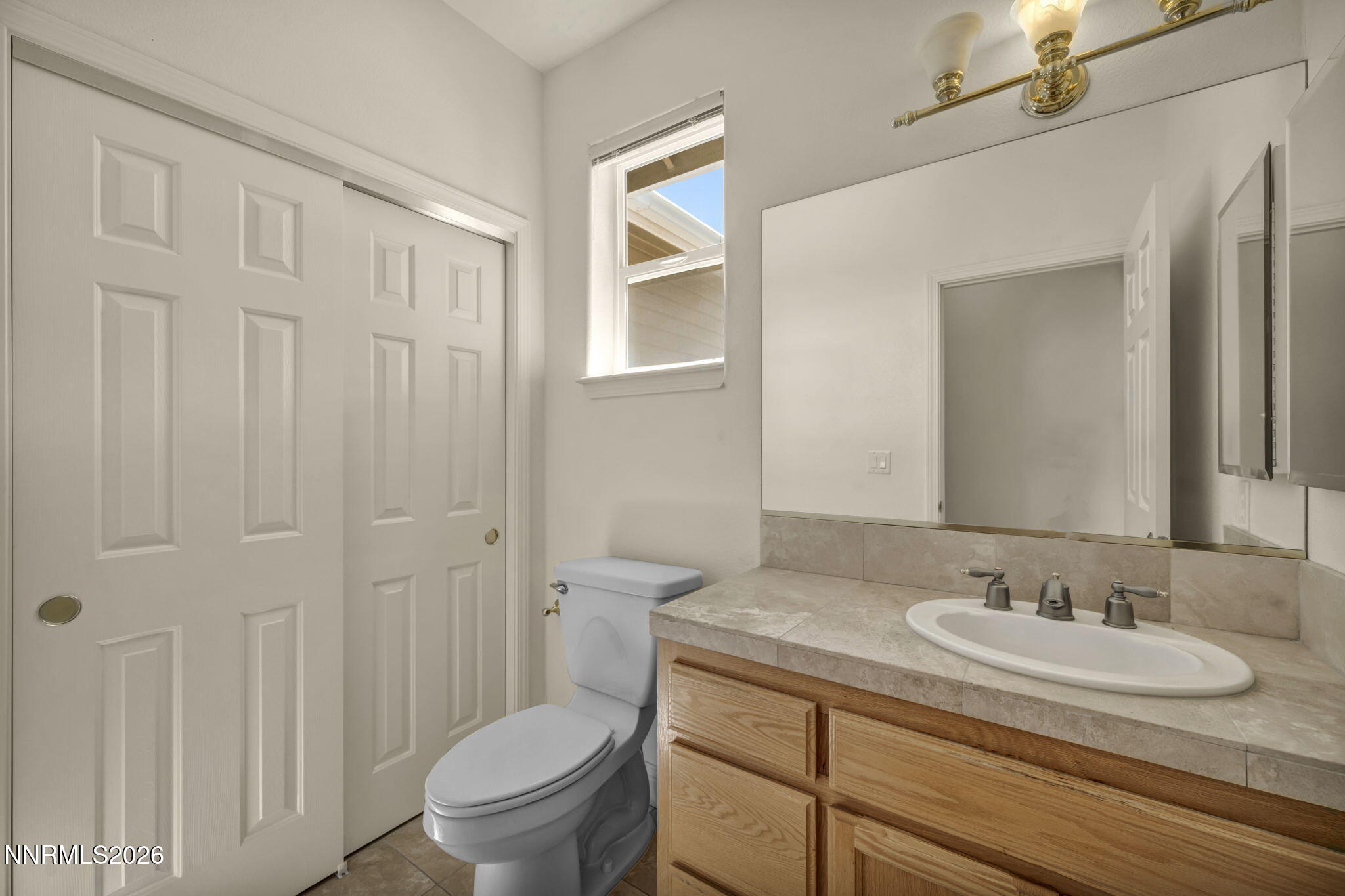 68 Kari Lane Smith Valley, NV 89430 - Photo 17 of 42 a bathroom with a granite countertop sink a toilet and a mirror
