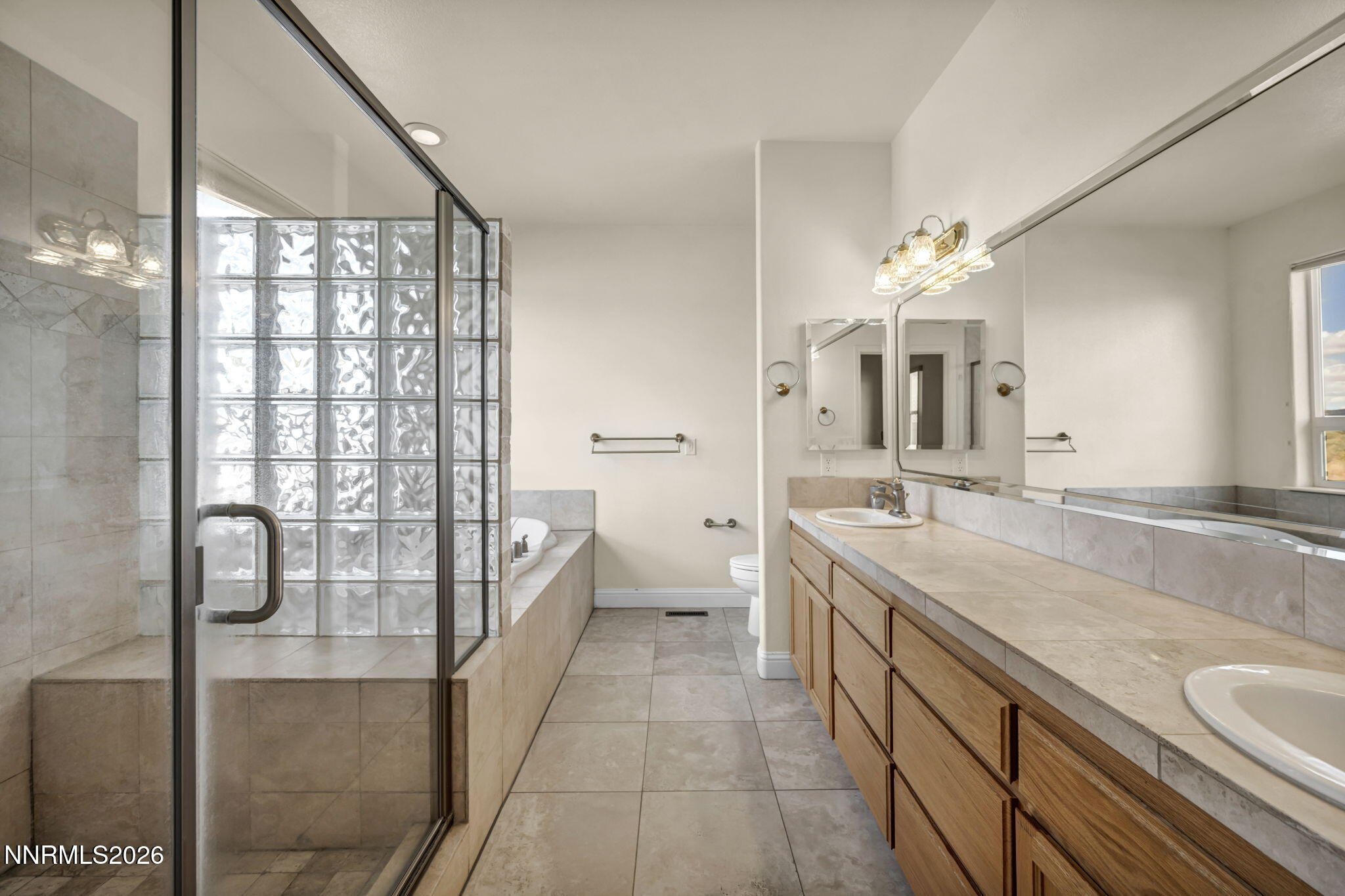 68 Kari Lane Smith Valley, NV 89430 - Photo 18 of 42 a spacious bathroom with a granite countertop sink a mirror and a shower