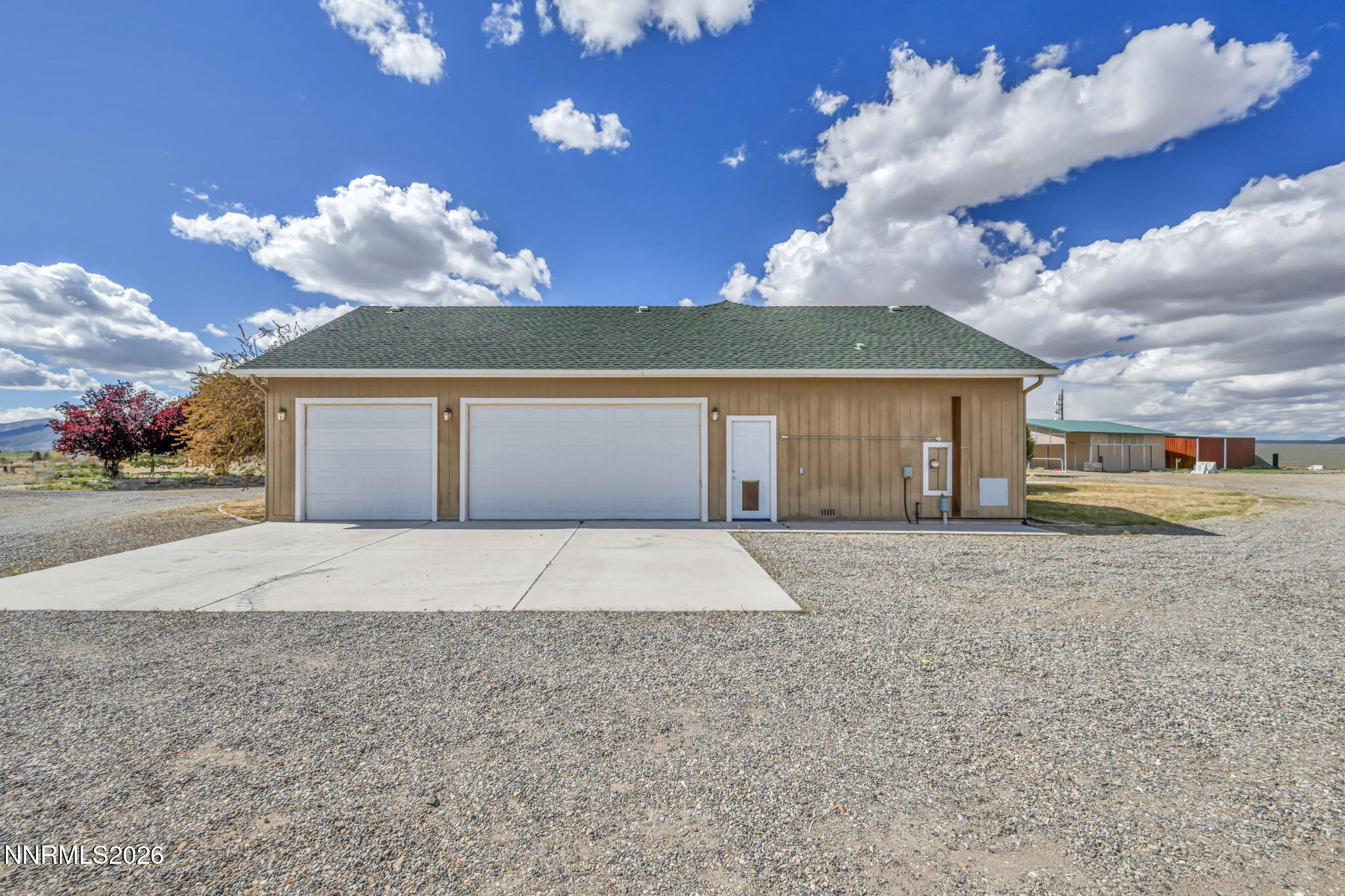 68 Kari Lane Smith Valley, NV 89430 - Photo 27 of 42 a front view of a house with a yard and garage