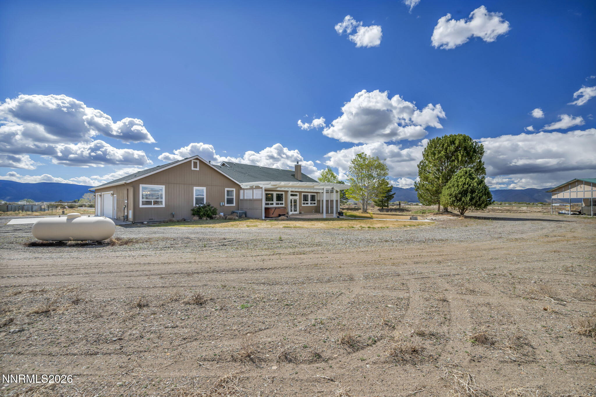 68 Kari Lane Smith Valley, NV 89430 - Photo 32 of 42 a front view of a house with a yard and chandelier