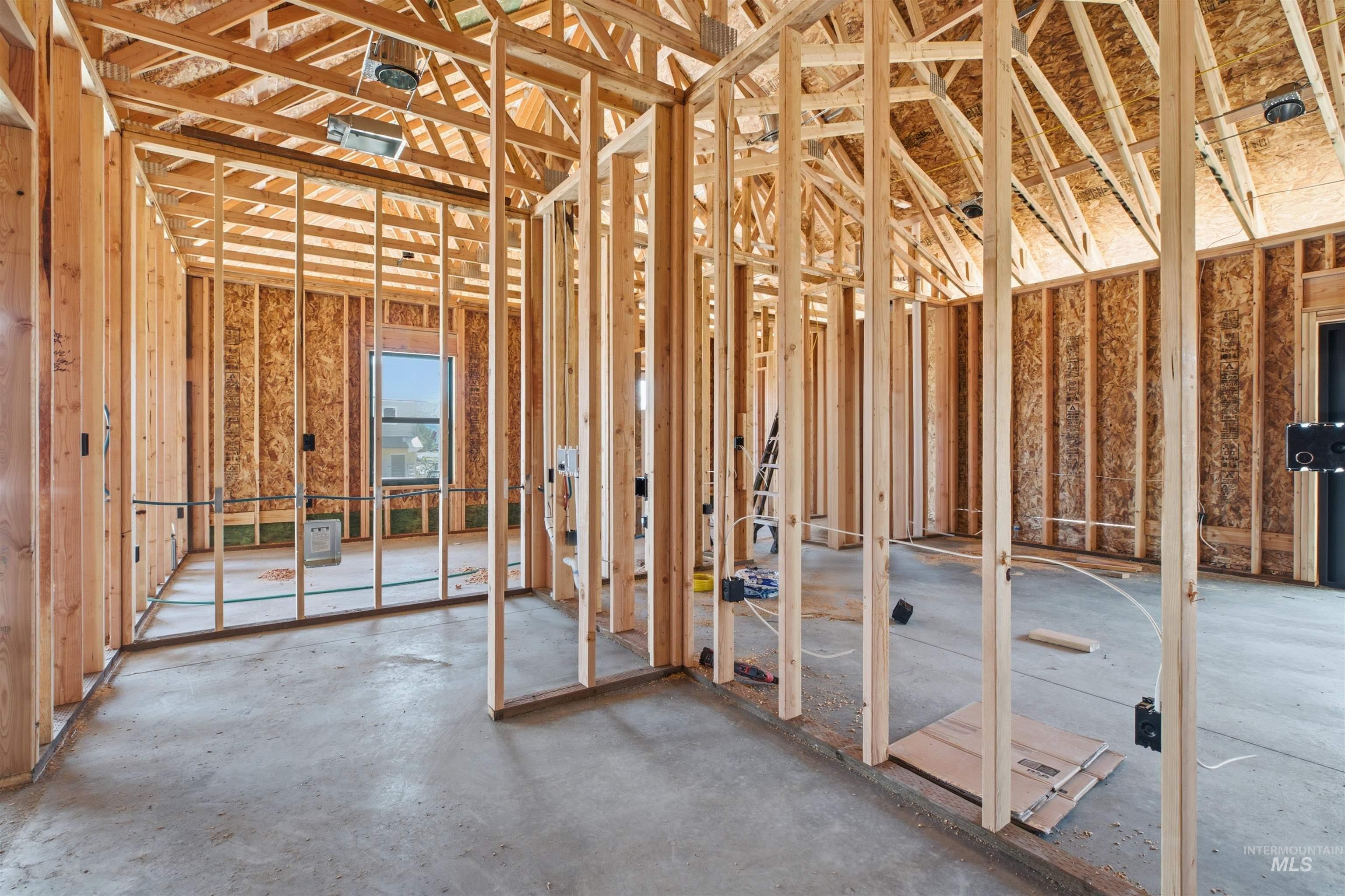 2824 Cyprus Court Moscow, ID 83843 - Photo 4 of 20 Interior framing showcasing wood studs, OSB sheathing, concrete subfloor, and an exposed ceiling truss system