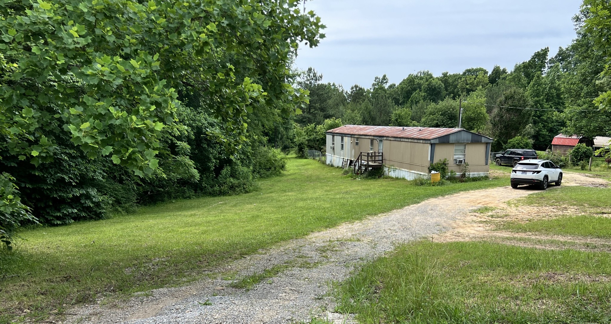 10338 Chappell Cemetery Road Bon Aqua, TN 37025 - Photo 1 of 21 a view of a house with backyard and sitting area