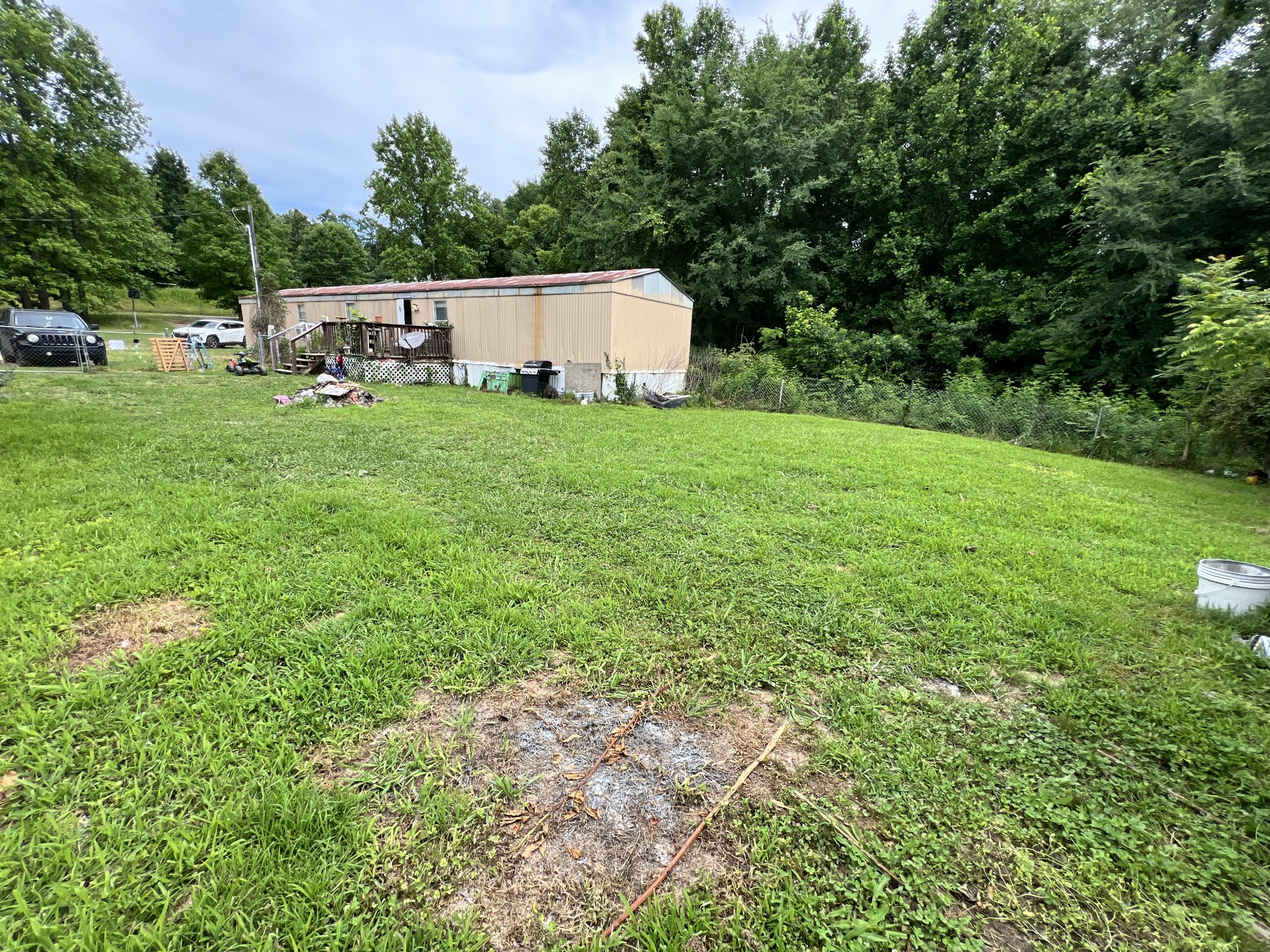 10338 Chappell Cemetery Road Bon Aqua, TN 37025 - Photo 3 of 21 a view of a house with backyard and sitting area