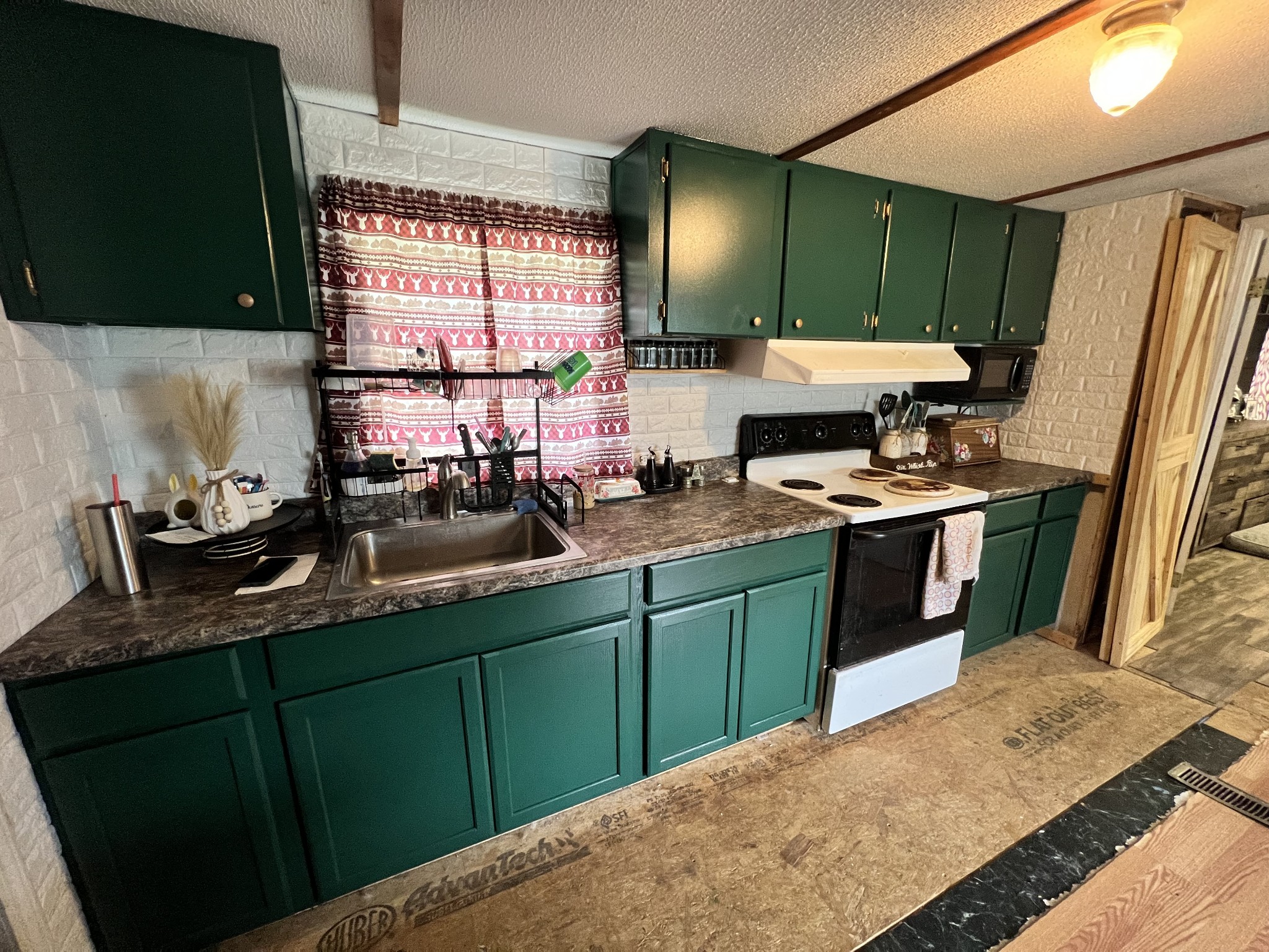 10338 Chappell Cemetery Road Bon Aqua, TN 37025 - Photo 10 of 21 a kitchen with stainless steel appliances a sink stove and refrigerator