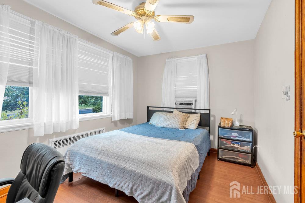 6 Carpender Road New Brunswick, NJ 08901 - Photo 18 of 30 a bedroom with a bed and a chandelier