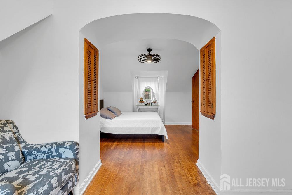 6 Carpender Road New Brunswick, NJ 08901 - Photo 19 of 30 a bedroom with a bed and wooden floor