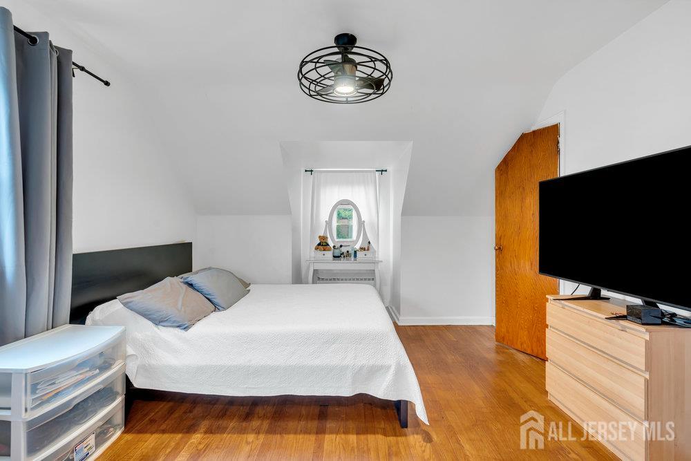 6 Carpender Road New Brunswick, NJ 08901 - Photo 21 of 30 a bedroom with a bed and a flat screen tv