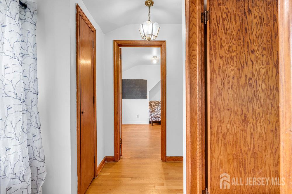 6 Carpender Road New Brunswick, NJ 08901 - Photo 23 of 30 a view of a hallway with wooden floor and a bathroom