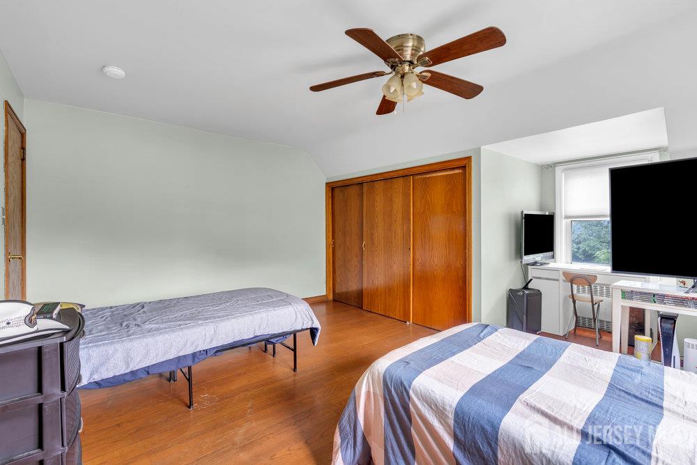 6 Carpender Road New Brunswick, NJ 08901 - Photo 27 of 30 a bedroom with a bed and a flat screen tv