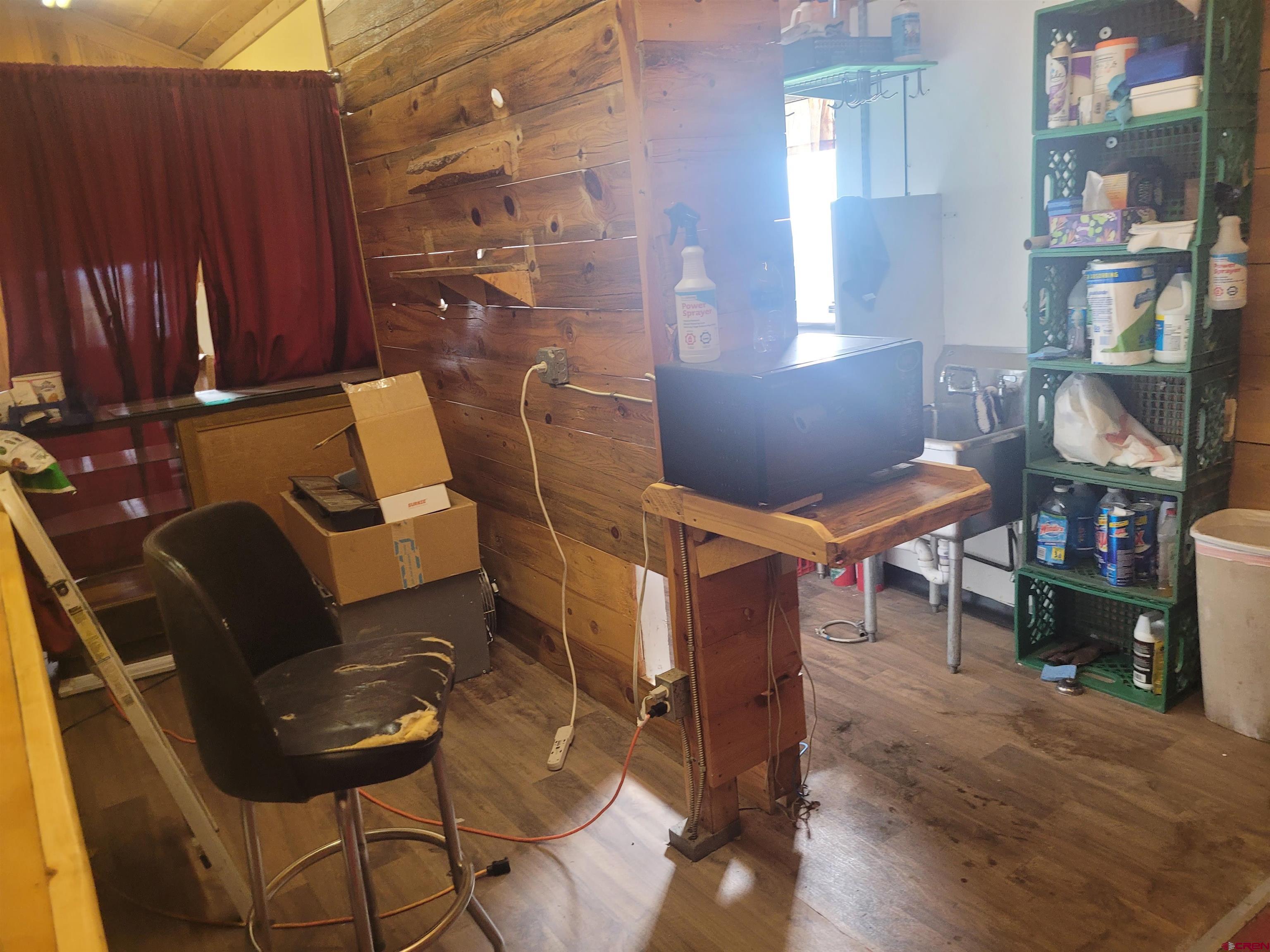25 Clyde Street Moffat, CO 81143 - Photo 5 of 10 a living room with furniture a wooden floor and a cabinet
