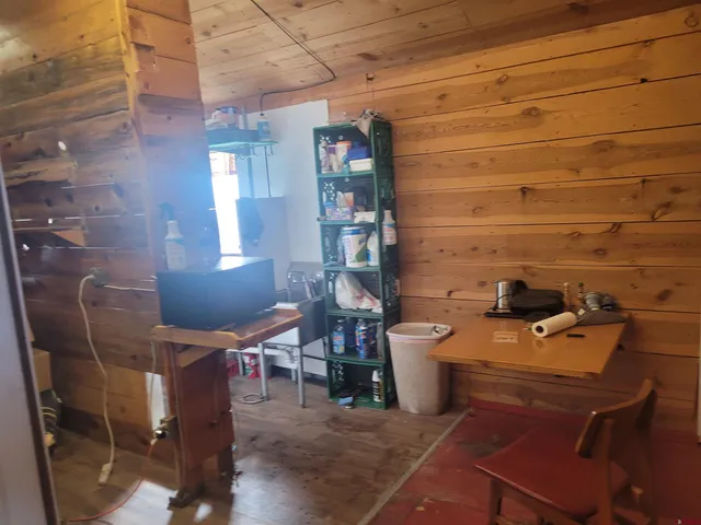 a room with chairs and chandelier