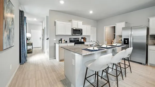 a front view of a house with a yard and trees