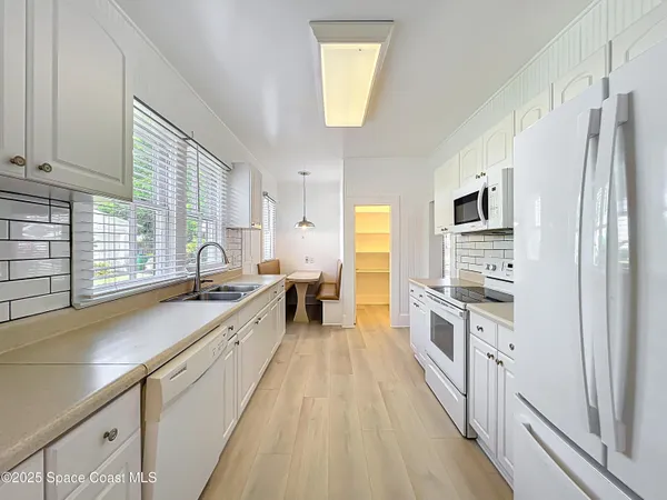 a large kitchen with stainless steel appliances granite countertop a lot of counter space and a sink