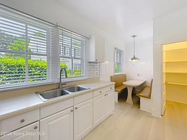 a kitchen with a sink and large window