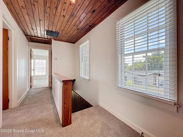 a view of a hallway with windows