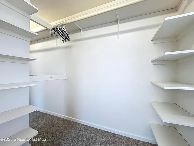 a view of a room with shelf on the wall