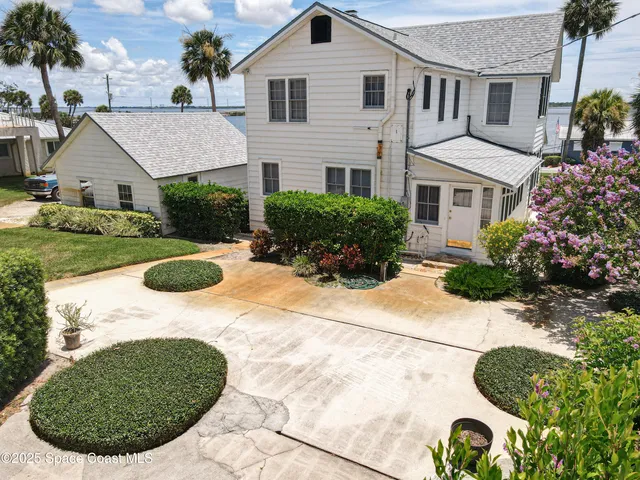 a view of a lake with a yard and a fountain in the back