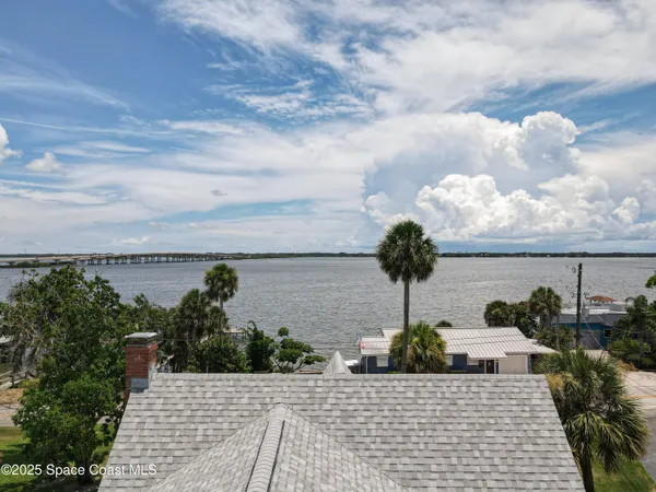 an aerial view of residential houses with outdoor space and street view